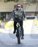 PREMIUM EXCLUSIVE Arnold Schwarzenegger Rocks Camo Arnold Classic Jacket As He Bikes To The Gym