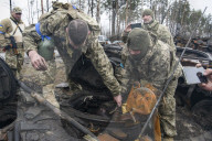 NEWS - Ukraine-Krieg: Ukrainische Soldaten inspizieren einen zerstörten russischen Panzer bei Kiew