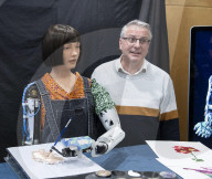 Ai-Da Robot painting at the British Library, Elliott Room, London,UK.
