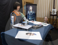 Ai-Da Robot painting at the British Library, Elliott Room, London,UK.
