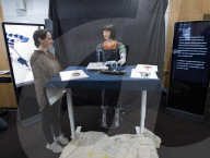 Ai-Da Robot painting at the British Library, Elliott Room, London,UK.
