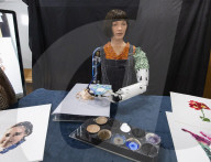 Ai-Da Robot painting at the British Library, Elliott Room, London,UK.
