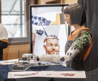 Ai-Da Robot painting at the British Library, Elliott Room, London,UK.
