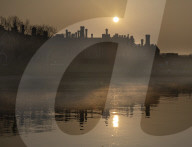 Sun rises over a misty River Thames