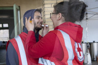 Red Cross volunteers distribute food and aid at Csengersimai on the Hungary Romania border.