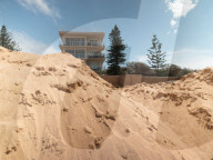 A 7m wall has gone up on a Sydney beach: are we destroying public space to save private property?