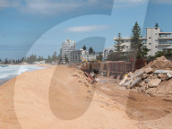 A 7m wall has gone up on a Sydney beach: are we destroying public space to save private property?