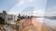A 7m wall has gone up on a Sydney beach: are we destroying public space to save private property?