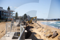 A 7m wall has gone up on a Sydney beach: are we destroying public space to save private property?