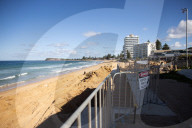 A 7m wall has gone up on a Sydney beach: are we destroying public space to save private property?