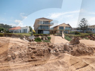 A 7m wall has gone up on a Sydney beach: are we destroying public space to save private property?