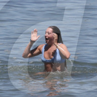 Bikini clad Ashley Tisdale enjoys a fun-filled day at the beach with husband Christopher French, their young daughter and a handful of friends on a scorching afternoon in Malibu. 