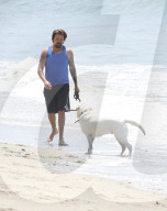 Sean Stewart is seen out for a walk on the beach in Malibu with his dog and a mystery woman, the day after 4th of July celebration. 