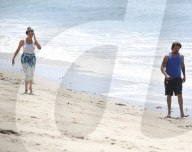 Sean Stewart is seen out for a walk on the beach in Malibu with his dog and a mystery woman, the day after 4th of July celebration. 
