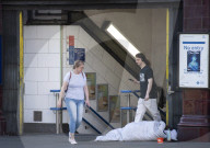 Rough sleeper laying across the exit of Oxford Circus tube statio