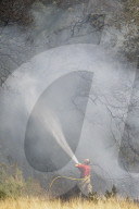 Firefighters put out a grass fire at Hollow Ponds in Leytonstone, East London.