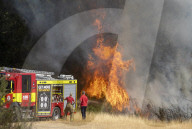 Firefighters put out a grass fire at Hollow Ponds in Leytonstone, East London.