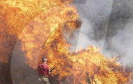 Firefighters put out a grass fire at Hollow Ponds in Leytonstone, East London.