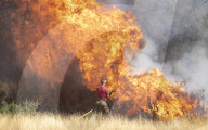 Firefighters put out a grass fire at Hollow Ponds in Leytonstone, East London.