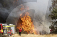 Firefighters put out a grass fire at Hollow Ponds in Leytonstone, East London.