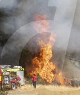 Firefighters put out a grass fire at Hollow Ponds in Leytonstone, East London.