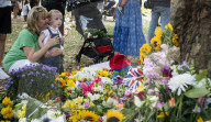 Floral tributes for HM The Queen Elizabeth II are left by mourners in Green Park London