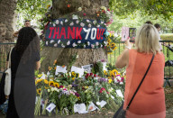 Floral tributes for HM The Queen Elizabeth II are left by mourners in Green Park London