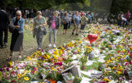 Floral tributes for HM The Queen Elizabeth II are left by mourners in Green Park London