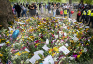 Floral tributes for HM The Queen Elizabeth II are left by mourners in Green Park London