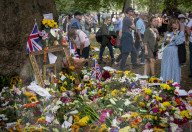 Floral tributes for HM The Queen Elizabeth II are left by mourners in Green Park London