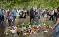 Floral tributes for HM The Queen Elizabeth II are left by mourners in Green Park London