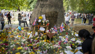 Floral tributes for HM The Queen Elizabeth II are left by mourners in Green Park London