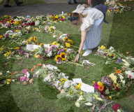 Floral tributes for HM The Queen Elizabeth II are left by mourners in Green Park London