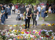 Floral tributes for HM The Queen Elizabeth II are left by mourners in Green Park London
