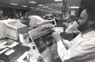 Eamonn McCabe holding newspaper dated 4 November 1992.