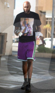 Lamar Odom is seen carrying a huge fistful of dollars as he runs errands