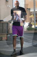 Lamar Odom is seen carrying a huge fistful of dollars as he runs errands
