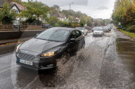 Public brave the flash flooding in Putney High Street south west London.