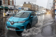 Public brave the flash flooding in Putney High Street south west London.