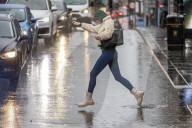 Public brave the flash flooding in Putney High Street south west London.