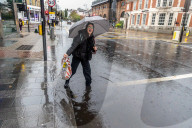 Public brave the flash flooding in Putney High Street south west London.