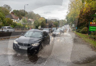 Public brave the flash flooding in Putney High Street south west London.