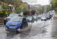 Public brave the flash flooding in Putney High Street south west London.