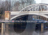 Public enjoy the views of the river Thames from footbridge that goes under the grade II listed Barnes Railway Bridge in south-west London.