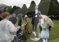 Public watch King Charles III Coronation on big screen at Hampton Court Palace, UK.