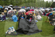 Public watch King Charles III Coronation on big screen at Hampton Court Palace, UK.