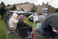 Public watch King Charles III Coronation on big screen at Hampton Court Palace, UK.