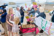 Portland Global Friendship Group at the gates to Portland Port waiting to welcome asylum seekers. Portland, Dorset 7th August 2023.