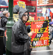 Anti-ULEZ protestors in Tooting Broadway London, Great Britain 
26th August 2023 

People campaigning to stop the ULEZ expansion which is due to commence on 29th August 2023 hold placards towards the traffic around Tooting Broadway