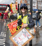 Anti-ULEZ protestors in Tooting Broadway London, Great Britain 
26th August 2023 

People campaigning to stop the ULEZ expansion which is due to commence on 29th August 2023 hold placards towards the traffic around Tooting Broadway